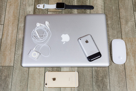 CHIANGMAI , THAILAND - FEB 8 2017: Macbook Pro computers and magic mouse with iPhone, Apple Watch and iPod on wooden.のeditorial素材