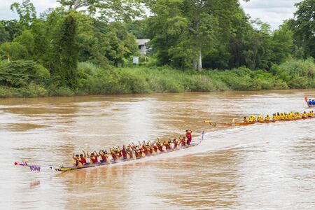 PHICHIT , THAILAND - SEP 8 2019: Thai Traditional Long Boat Racing 2019 At Nan River in front of Tha...