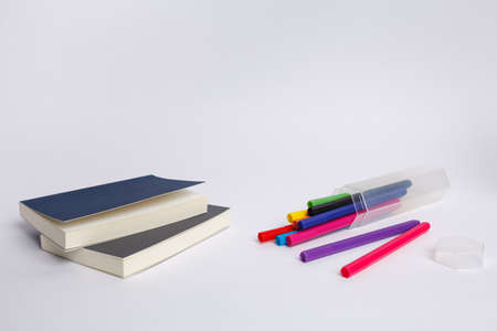 Notebook with school supplies on a white background