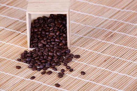Coffee cup and coffee beans on brown wood table backgroundの写真素材