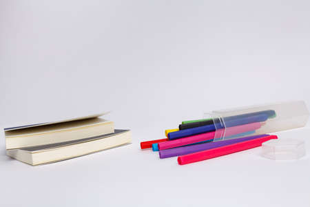 Notebook with school supplies on a white background