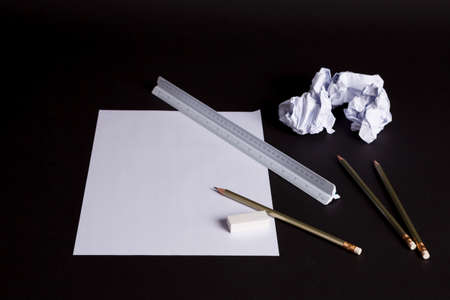 paper on the Black table with a pencil creativeの写真素材