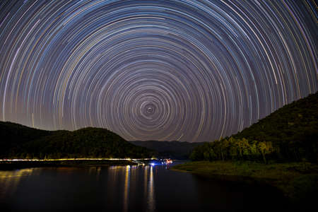 Bright Colorful Star Trails On The Lake.の写真素材