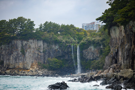Jeongbang Waterfall an famous waterfall on Jeju Islandの写真素材