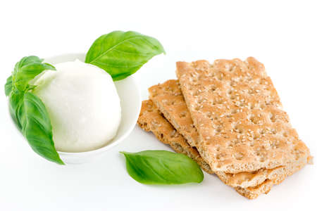 Cheese mozzarella  ball with basil leaf isolated on whiteの写真素材
