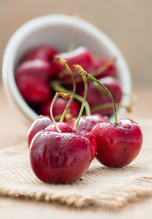 Cherries on wooden table with water dropsの写真素材