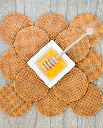 Dutch Waffles with honey on wooden backgroundの写真素材
