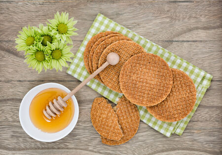 Dutch Waffles with honey on wooden backgroundの写真素材