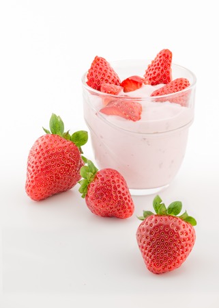 Fresh strawberry with yogurt in a glass isolated on whiteの写真素材