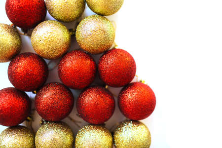Close up of red and golden Xmas balls decoration pile. Overview of shiny baubles. Festive backdrop.の写真素材