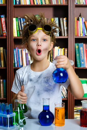Cute boy doing biochemistry research in chemistry class.の写真素材