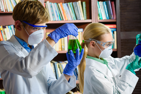Cute boy and girl doing biochemistry research in chemistry class.の写真素材