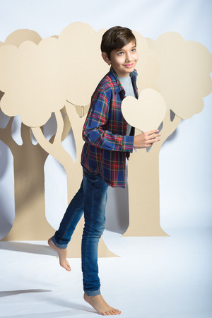 Lover Boy holding a cardboard heart. Love concept.の写真素材