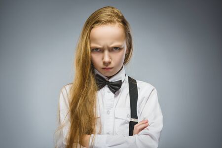 Portrait of offense girl isolated on gray background. Negative human emotion, facial expression....