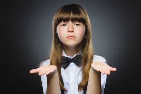 Portrait of offense girl isolated on gray background. Negative human emotion, facial expression. Closeup.の写真素材