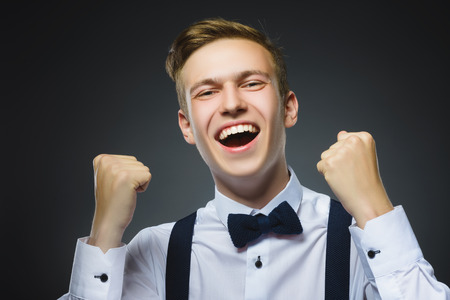 Closeup portrait successful happy boy isolated grey background. Positive human emotion face expression. Life perception achievement vision.の写真素材