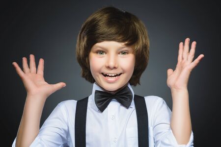 Closeup Portrait of happy boy going surprise isolated on gray background.