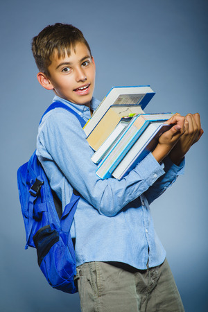 school concept. portrait successful happy boy with knapsack holding books.の写真素材