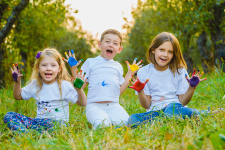 Children having fun painting with finger paint.の写真素材