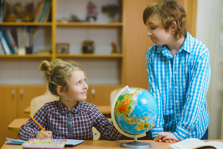 boy and girl on the geography lesson in school classroom. Educational conceptの写真素材