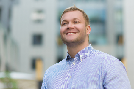 Portrait of happy Handsome businessman in blue shirt outdoor