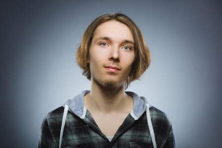 Happy child. Portrait of handsome boy smiling isolated on grey backgroundの写真素材