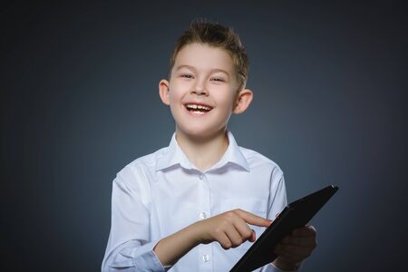 smiling young boy or teenager with tablet pc computerの写真素材