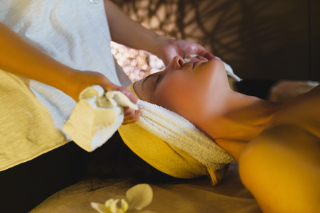 Massage therapist massaging beautiful brunetteの写真素材