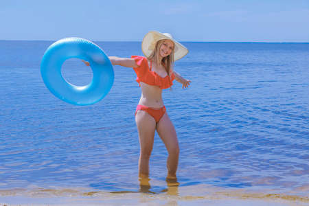 Girl on the beach at sea with a circle
