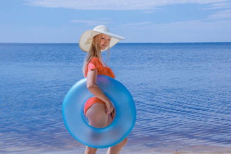 Girl on the beach at sea with a circle