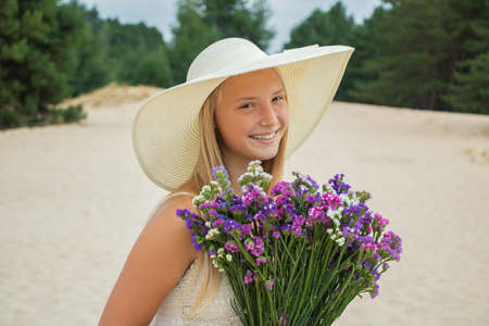 guy and girl with a bouquet of beautiful color in nature in autumn and summer on a dateの写真素材