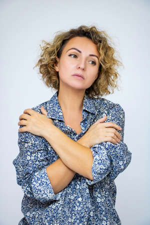 Beautiful woman in a shirt, sad, dejected, depressed, emotion of emptiness, close-up portrait, on a...