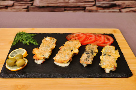 vegetarian vegetarian dish cheese sticks on a black plate healthy food proper foodの写真素材