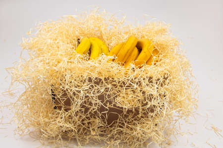 box with bananas close-up on white backgroundの写真素材