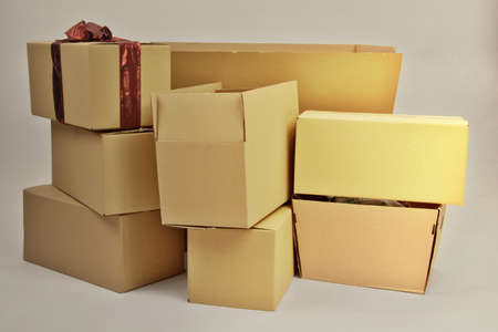 A lot of cardboard boxes brought from a warehouse, close up on a white background