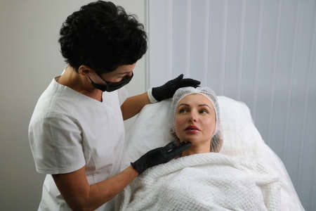 The patient at the beautician after the lip augmentation procedure.