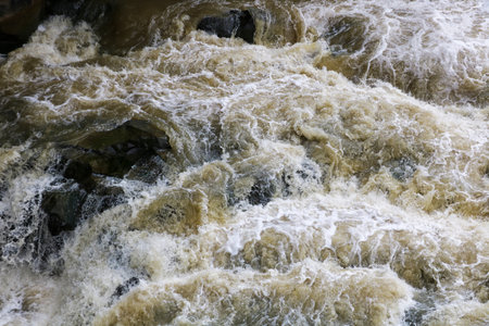 A stormy mountain river with rocky banks