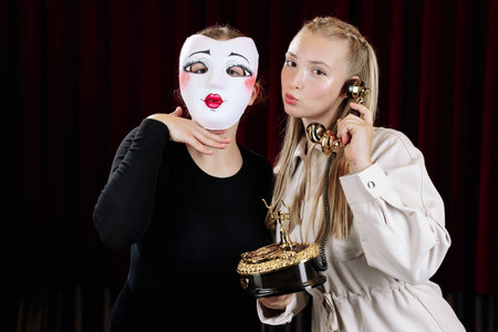 Close-up of two theatre actresses displaying strong emotions in their rolesの写真素材