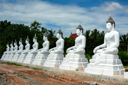 White buddah statue on blue sky backgroundの写真素材