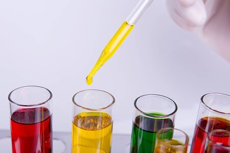 Liquid dripping from pipette into test tubeの写真素材