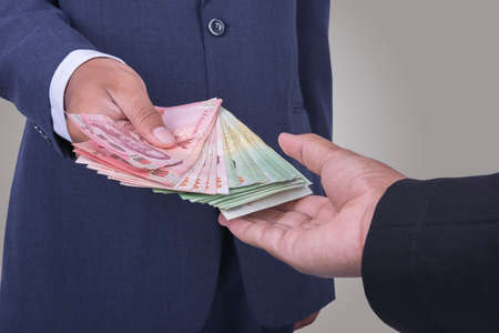 Man gently takes a bribeの写真素材