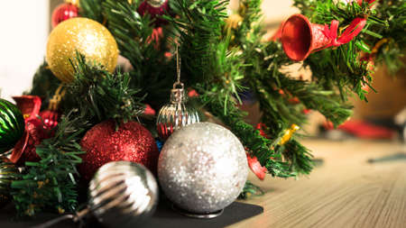 Horizontal image close up and selective focus red wrinkle Christmas ball hanging on Christmas tree...