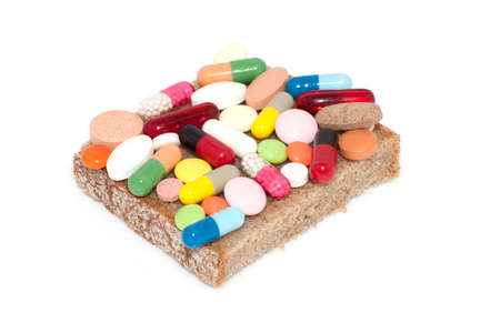 Various pills, capsules and tablets on rye bread