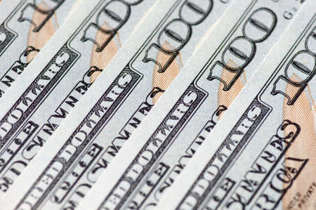 One hundred dollars bank notes in row close up