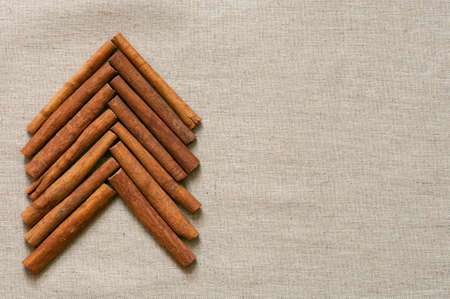 Christmas tree made of cinnamon sticks on linen backgroundの写真素材