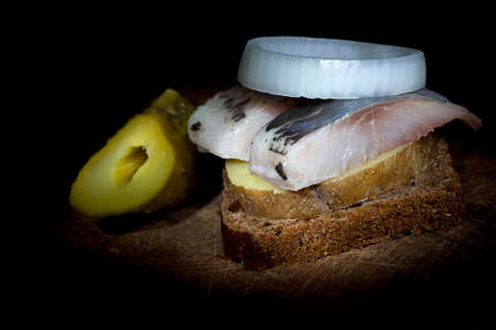 Sandwich made of herring on boiled jacket potato and rye breadの写真素材