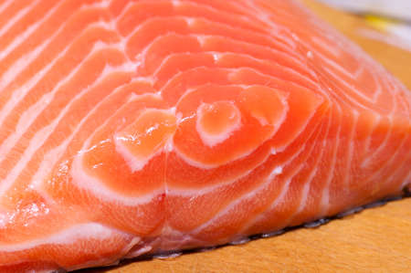 Fresh salmon fillet salted with coarse sea salt close upの写真素材