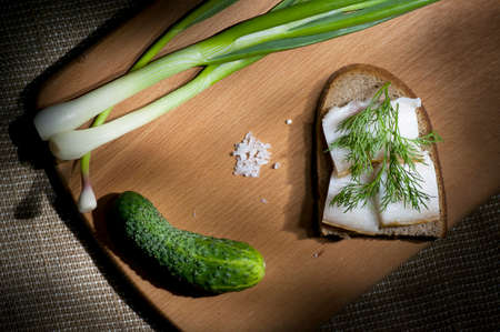 Sandwich with salted lard on rye bread served with green onion and garlic