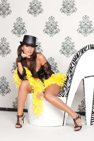 Glamoured portrait of fancy cabare dancer sits on high heel shoeの写真素材