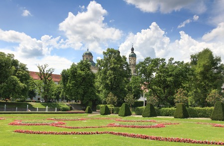 Blooming court garden in spring with church and trees.